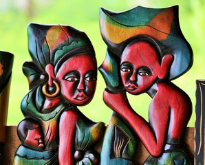 detail of a wooden colored statue representing a couple with a baby in sao tome and principe