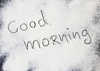 good morning inscription on the board with flour.