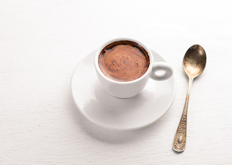 Espresso coffee cup on a white wooden background. Top view. Free space for text.