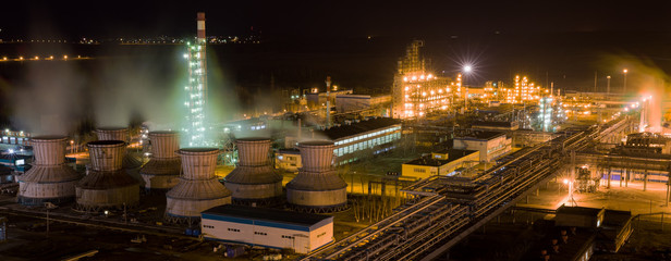panorama of large chemical plant at night with light