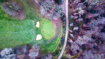 Drone view of a golf course with beautiful nature and a footpath
