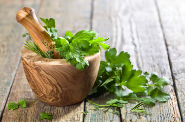 Wooden mortar with Different herbs .