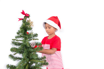 Cute little boy with decorating Christmas tree