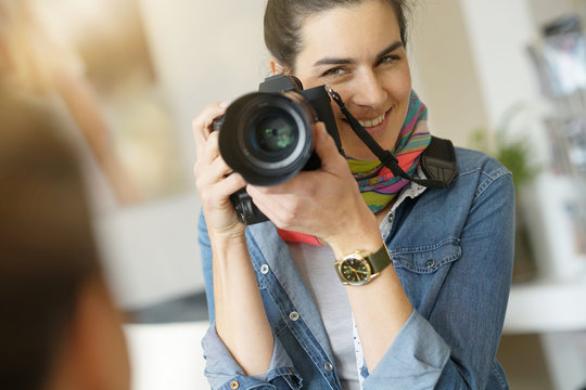 Portrait of woman photographer on a shooting day
