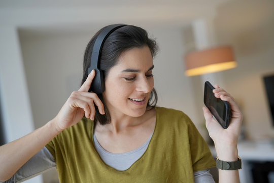 Woman listening to music with bluetooth headset