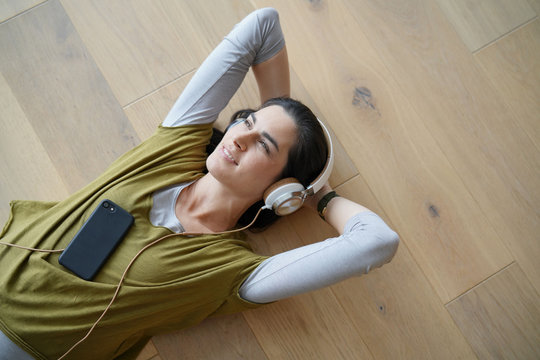 Woman listening to music with smartphone and headphones