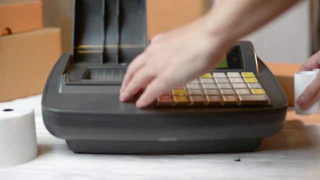 Woman working with Electronic Cash Register