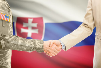 USA military man in uniform and civil man in suit shaking hands with adequate national flag on background - Slovakia