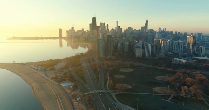 Flying above the beach and park in Chicago Downtown at sunrise. Morning light with vintage colors