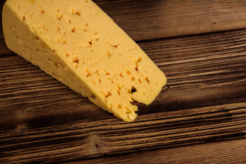 Piece of cheese on wooden table