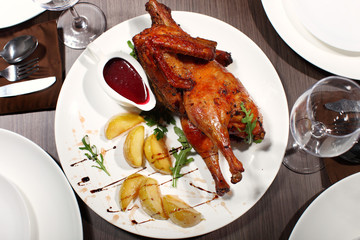 Roasted chicken seasoned with herbs and potatoes