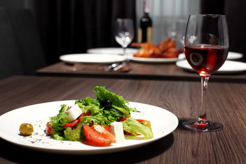 luxury dinner served on the table with glass of red wine
