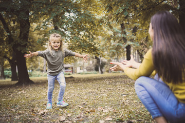 Little girl running to her mother in embracing.