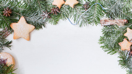 Ginger homemade cookies with strawberry jam on white wooden background with Christmas tree. Winter holidays concept. Flat lay, top view. Xmas Border - horizontal banner. Web size. 