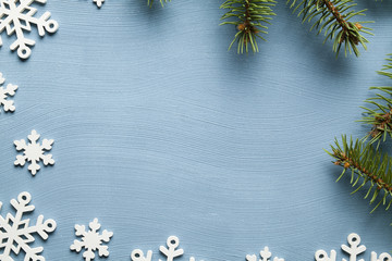 Christmas background - spruce tree and snowflakes on blue background