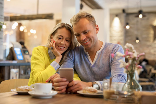 Couple looking at smartphone together