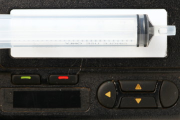 Old and dirty pager in the scene have syringe at the screen also.