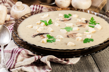 Mushroom cream soup with croutons and spices