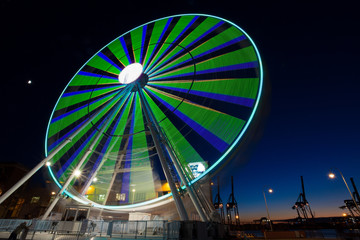GENOA, ITALY, NOVEMBER 27, 2017 - Ferris wheel with colored lights in "Porto Antico" harbor zone in Genoa, Italy