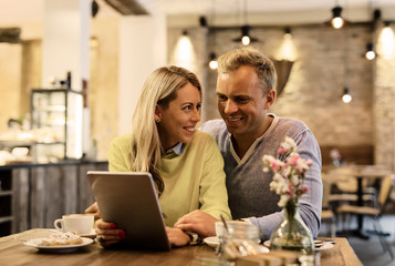 Couple discussing something on digital tablet