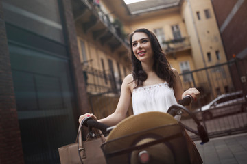 Obraz na płótnie Canvas Portrait of beautiful young woman enjoying time on bicycle
