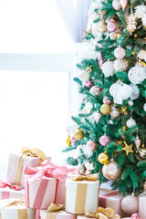 Christmas living room with a Christmas tree, gifts and a large window. Beautiful New Year decorated classic home interior