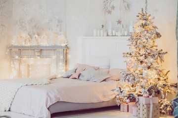 Christmas living room with a Christmas tree, gifts and bed. Beautiful New Year decorated classic home interior. Winter background