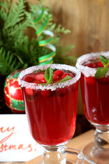 Hot cranberry tea in an Irish mug decorated with sugar on a wooden board
