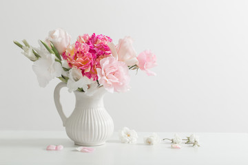 pink and white flowers in vase on white background