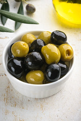 Olives with olive branch and olive oil, view from above