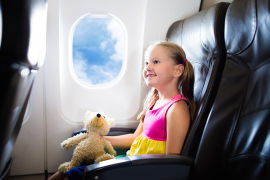 Child in airplane. Flight with kids. Family flying.