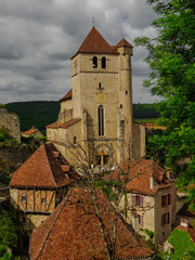 Fototapeta na wymiar Saint Cirq Lapopie fortified medieval church in France on a cloudy day.