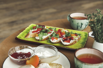 close-up view of gourmet sandwiches and tea on table at breakfast