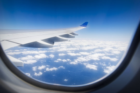 Looking Out Airplane Window , Airplane Wing And Clouds