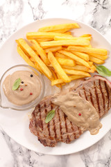 grilled steak with pepper sauce and french fries