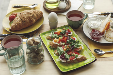 close-up view of fresh tasty sandwiches and breakfast on table