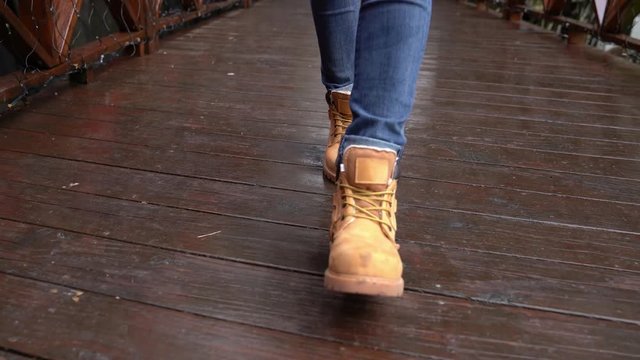 women feet wearing hiking boots walking