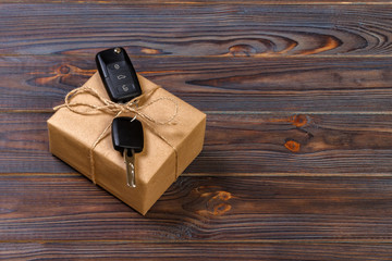 car key and gift box on dark background