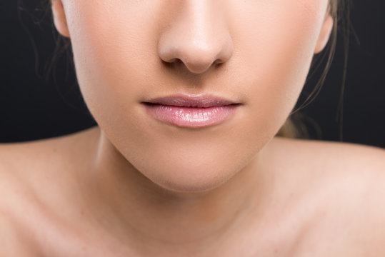 Closeup view of female lips with delicate lipgloss