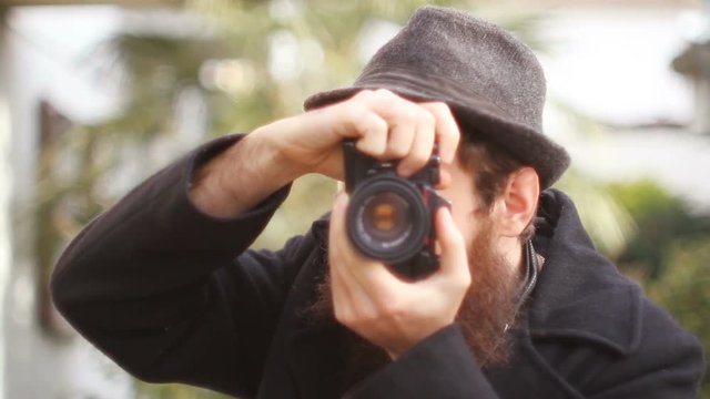 Photographer With Beard Takes Photo With Vintage Camera