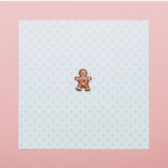 gingerbread man on background with pink dots and frame. Happy New Year and merry Christmas minimal concept.