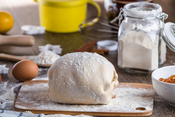 piece of wheat dough on a wooden board