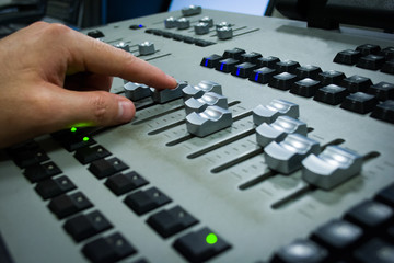 hand on a light, mixing desk fader in blur television gallery