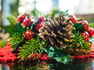 Christmas decorated table with cones in cozy and warm home