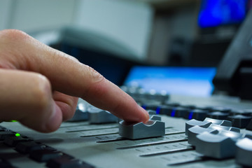 hand on a light, mixing desk fader in blur television gallery