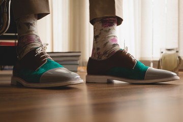 Man in casual shoes standing at home
