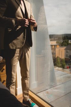 Man wearing his blazer in bedroom