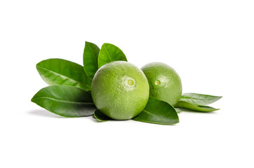 two green limes with leaves isolated on white background