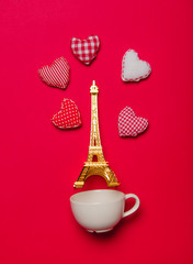 White cup and heart shapes with Eiffel tower statuette