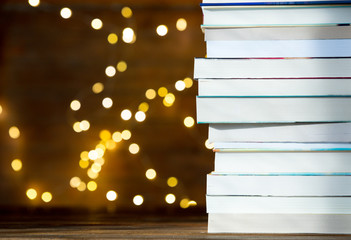 Pile of books with fairy lights